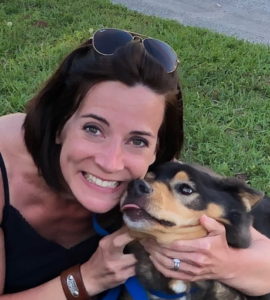 A female hugging her dog