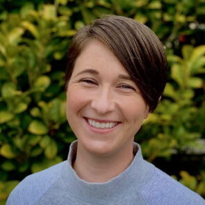 Photo of Dr. Megan Buchanan in a blue shirt and a big smile.