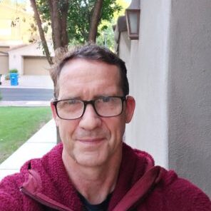 Man wearing eyeglasses and a red hoodie