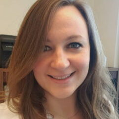 A smiling female with brown hair